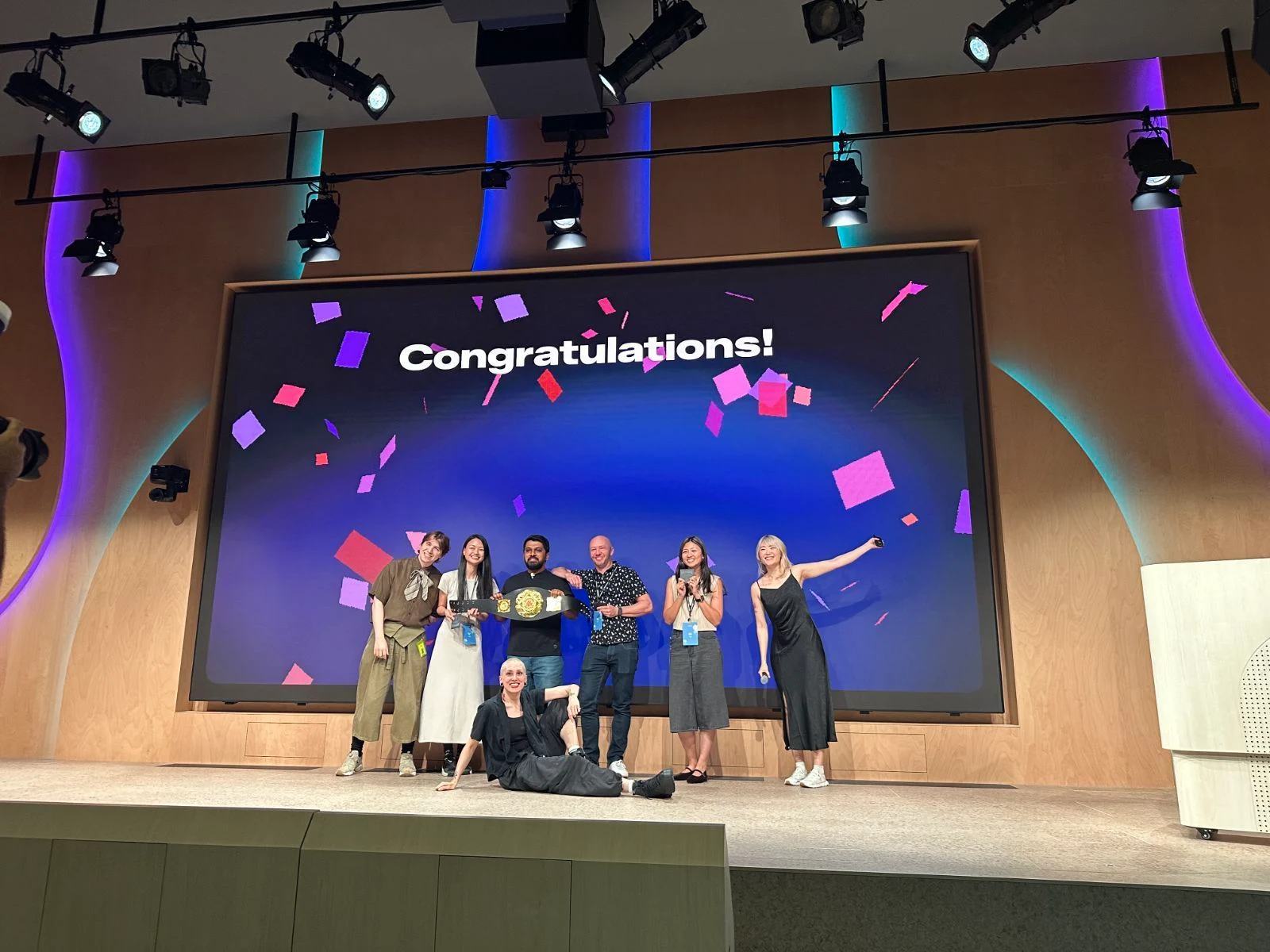 Contest winners on stage at a Vibe Coders Tokyo build night, audience clapping