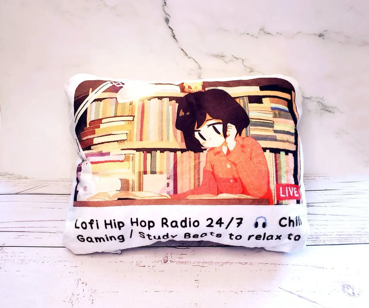 A plush cushion printed with the lo-fi hip hop radio study-girl stream thumbnail, reading 'Lofi Hip Hop Radio 24/7 — Gaming / Study Beats to relax to'